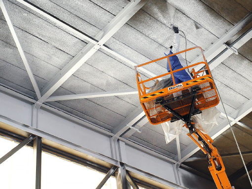 Man with sprayer on cherry picker